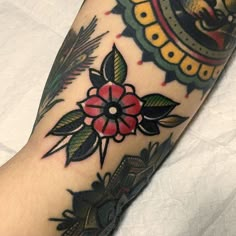 a person's foot with tattoos on it, and an image of a flower