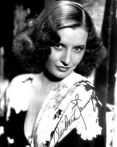 an old black and white photo of a woman wearing a dress with the name barbara on it