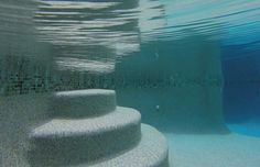 an underwater view of some steps in the water