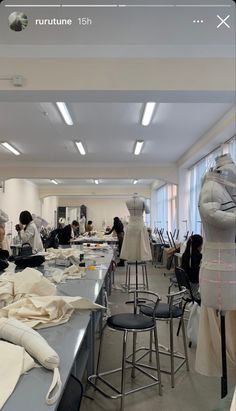 a room filled with lots of mannequins and tables