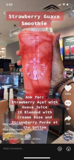 someone holding up a red starbucks cup in front of a computer screen with the text strawberry guava smoothie on it