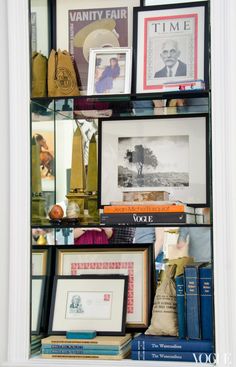 a book shelf filled with books and pictures