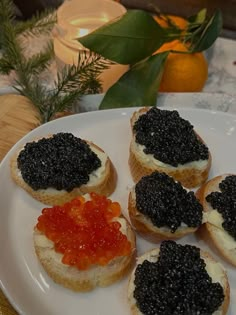 several small pieces of bread with black cavia on them