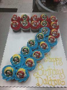 a birthday cake with cupcakes on it