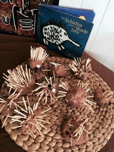 the hedgehogs are made out of straw with toothpicks on them and an open book