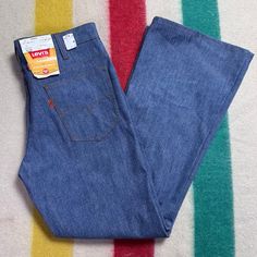 Levi's 946 High Waisted Bell Bottom Jeans From 1975 Brand - Levi's Content - 50% Dacron Polyester 50% Cotton Size - Labeled Husky 33 Waist - 16.5" Across Measured Flat, 16.75" Pulled Taut Hips - Approx 19" Across Rise - 12" Inseam - 29" Outseam - 40" Thigh - 11.75" Across Leg Opening - 10.75" Across Condition - Brand New With Tags Levis Bell Bottom Jeans, Retro Blue Jeans For Fall, Levi's Wide Leg Blue Pants, Retro Levi's Bottoms With Pockets, Vintage Fitted Blue Jeans, Retro Blue Bottoms For Fall, Fitted Retro Levi's Bottoms, Vintage Blue Bottoms With Standard Cut Leg, Fitted Blue 1970s Style Bottoms