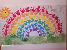 a child's drawing of a rainbow with hand prints