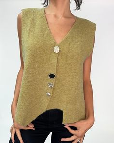 Introducing the eleanor sweater vest. Featuring a soft gold with an eclectic collection of buttons, each varying in shape and size The relaxed fit makes it great for layering or wearing alone. Pair it with oversized trousers, slip skirts, or your favorite denim for a chic look. CONTENT + CARE Wool/Acrylic Machine wash cold SIZE + FIT True to size Fitted Modeled in size Small