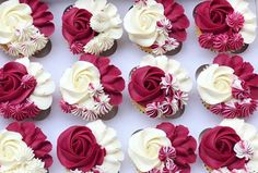 the cupcakes are decorated with white and red flowers