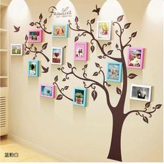 a family tree with many pictures on it and birds flying around the tree, in front of a white wall