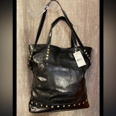 Steve Madden Black Gold Studded Handbag Tote Faux Leather Shoulder Bag. Great Bag To Carry Picnic Items Or Go To The Beach - Fancy Gym Bag Or Travel Luggage. The Interior Of The Bag Is 100% Cotton With A Black And White Herringbone Print. The Tote Measures 17” High, 17” Deep, 5” Wide, 8” Shoulder Drop And Has Carry Handles Also. Brand New With Tags! Fast Shipping! Trendy Double Handle Bag With Snap Closure, Edgy Bags For Everyday Use In Fall, Edgy Everyday Bags For Fall, Fall Shoulder Bag With Gold-tone Hardware For Shopping, Edgy Black Leather Satchel, Top Handle Faux Leather Shoulder Bag With Metal Hardware, Faux Leather Shoulder Bag With Metal Hardware, Faux Leather Top Handle Shoulder Bag With Metal Hardware, Shopping Hobo Bag With Metal Hardware And Double Handle