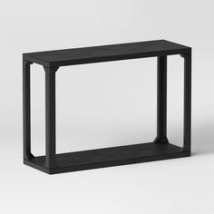 a black table with two legs on the top and one leg raised up to the side