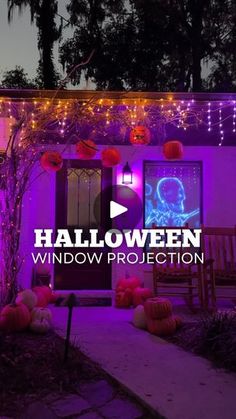 the halloween window projection is displayed in front of a house with pumpkins and decorations