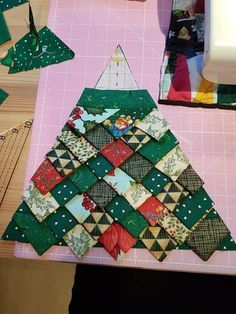 a quilted christmas tree on a cutting board