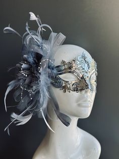 The mask boasts an intricate and mesmerizing design that showcases your unique style and elegance. Shimmering rhinestones adorn the mask, adding a touch of opulence and mystique to your look. Delicate silver feathers cascade from the mask, creating an aura of ethereal beauty and grace.


Age Group/Gender - Adult/Women

Size/Type - One size fits all adults

Mask Color - Silver

Mask Material - Laser cut metal

Special Features - Feather and rhinestones Water Mask Design, Unique Masquerade Mask, Mascerade Masks Outfit, Mermaid Masquerade Mask, Maskerade Mask Ideas, Light Blue Masquerade Mask, Object Refrences, Meg Aesthetic, Elegant Masquerade Mask