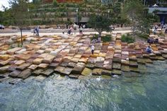 people are standing on rocks in the water near some steps that have been built into them