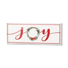 a white and red joy sign with a wreath on it