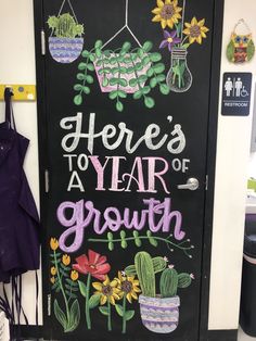 there's a year of growth written on a chalkboard in front of a door