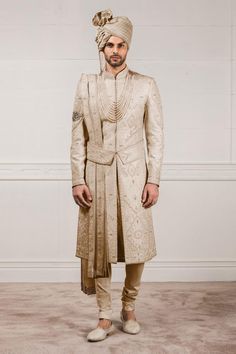 Ivory sherwani with all-over aari, zardozi work paired with kurta and churidar. Comes with safa, stole, kamarbandh and jutti fabric.
Components:7
Embroidered
Neckline:Mandarin Collar
Sleeve Length:Sherwani: Full
Fabric:Raw Silk, Jacquard, Cotton Silk and Chanderi
Color:White
Side slits
Closure: Sherwani: Concealed front placket
Note: Necklace and arm bracelet worn by the model is not for sale - Aza Fashions Peach Sherwani, Gents Shirts, Embroidered Sherwani, Designer Bridal Lehenga Choli, Zardosi Embroidery, Mens Sherwani, Gents Kurta, Kurta Men, Mens Kurta Designs