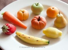 a white plate topped with different types of fruits and vegetables