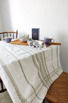 the table is set with two cups and a book on it, along with other items