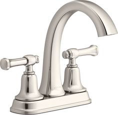 a chrome faucet with two handles