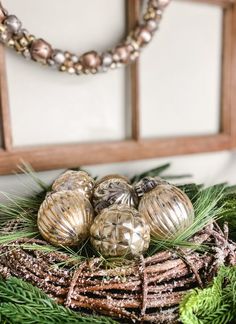 some ornaments are sitting on top of the wreath