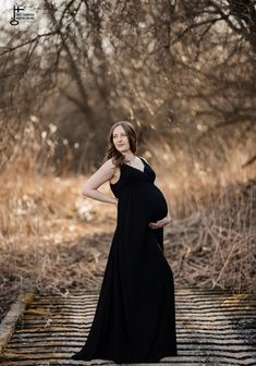 SUNSET Black flowy dress with straps | Maternity dress for photoshoot | Plus size maxi dress | Black pregnancy gown | Jenny Aarrekangas SUNSET is a black flowy dress for maternity photography and pregnancy.  The pregnancy dress is perfect as a summer maxi dress on the beach.  It is a minimalistic maternity gown that also can be worn on special occassions. The spaghetti strap maxi dress is designed for a comfortable fit and elegant silhouette. Can be worn during pregnancy or after. The dress has wide straps with a deep faux wrap neckline. Thanks to the long waist bands, you can adjust the waistline for a proper fit. The colour of the rayon crinkle dress is black. The dress is oversize length with a small train. One size, S-XL maternity size.  Skirt: A-line, one layer of fabric. Adjustable w Elegant Maxi Maternity Dress For Beach, Elegant Beach Maternity Maxi Dress, Elegant Maxi Length Maternity Dress For Beach, Black Sleeveless Summer Maternity Dress, Black Maternity Maxi Dress, Black Flowy Dress, Winter Maternity Photos, Dress For Photoshoot, Pregnancy Pics