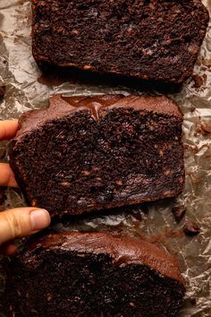 two pieces of chocolate cake sitting on top of foil