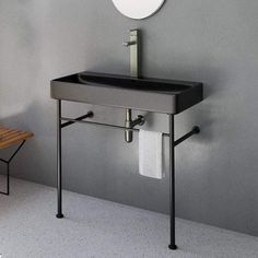 a bathroom with a sink, mirror and bench next to the toilet paper roll dispenser