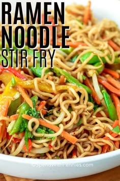 a bowl filled with noodles and vegetables on top of a wooden cutting board next to chopsticks