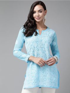 Introducing our enchanting Sky Blue Chikankari Short Kurti, crafted from delicate Georgette fabric! This stunning piece showcases the beauty of Chikankari embroidery and is perfect for those seeking elegance and grace. Please note that the Georgette fabric used in this kurti is intentionally designed to be semi-transparent, adding an ethereal touch to your outfit. To ensure modesty and maintain the intricate details of the Chikankari work, it is essential to wear an inner garment underneath. The model featured in the picture is wearing an inner garment to demonstrate the perfect pairing and provide clarity on the overall look. Please kindly note that the inner garment is not included with the purchase of this kurti. Our Sky Blue Chikankari Short Kurti is a versatile addition to your wardro Blue Fitted Tunic Kurta, Blue Chikankari Embroidery Salwar Kameez For Spring, Blue Salwar Kameez With Chikankari Embroidery For Spring, Spring Blue Salwar Kameez With Chikankari Embroidery, Fitted Blue Blouse With Chikankari Embroidery, Blue Georgette Blouse Piece With Floral Embroidery, Traditional Blue Top For Eid, Blue Self Design Georgette Kurta, Blue Chikankari Embroidery Blouse For Navratri