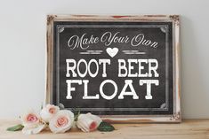 a wooden sign that says make your own root beer float with flowers on the table