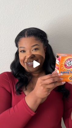 a woman holding up a box of toilet paper in front of her face and making a funny face