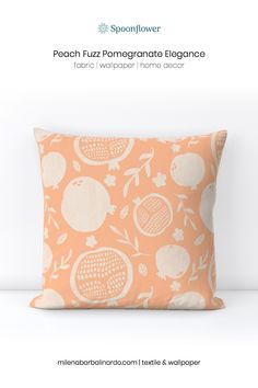 an orange and white pillow with pomegranates on it