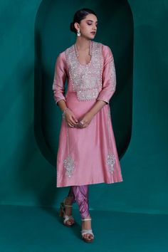 Rose pink chanderi tunic with sequin, badla and silver zari embroidery and pearl lace. Paired with a tulip pant and dupatta.
Components: 3
Pattern: Embroidered
Type Of Work: Zari, Sequin, Badla
Neckline: U Neck
Sleeve Type: Three-quarter
Fabric: Modal Satin, Georgette Organza, Organza
Color: Pink
Other Details: 
Approx. product wieght: 4 -5 kgs
Occasion: Mehendi and Haldi - Aza Fashions Pink Raw Silk Kurta With Mirror Work, Pink Slub Silk Kurta With Dabka Work, Pink Slub Silk Salwar Kameez With Straight Kurta, Pink Slub Silk Kurta For Eid, Pink Chikankari Embroidery Kurta For Reception, Pink Kurta With Chikankari Embroidery For Reception, Pink Kurta For Eid Reception, Pink Bollywood Style Kurta For Reception, Pink Long Sleeve Churidar