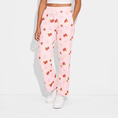 Step out in style with the Women's Strawberry Shortcake Cozy Graphic Pants – Pink. Crafted from a comfortable blend of cotton and polyester, these pants are suitable for all-day wear. The jersey fabric provides a soft feel, while the midweight design ensures year-round comfort. With their straight-leg fit, these pants offer a flattering and on-trend look. Whether you're running errands or relaxing at home, these pants are sure to become a wardrobe staple. Casual Sleepwear Straight Pants For Pajama Party, Casual Sleepwear Trousers With Elastic Waistband, Casual Cotton Sleepwear Trousers, Casual Sleepwear With Relaxed Fit Trousers, Casual Wide Leg Sleepwear, Casual Spring Sweatpants For Pajama Party, Casual Sweatpants For Pajama Party In Spring, Trendy Cotton Joggers For Lounging, Cotton Loungewear Pants With Comfort Waistband