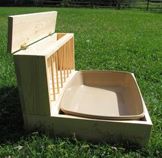 an empty wooden box sitting in the grass