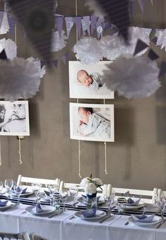 the table is set with blue and white plates, napkins, and pictures hanging on the wall