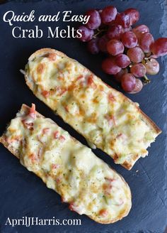 two pieces of bread sitting next to grapes on a slate platter with the words quick and easy crab melts