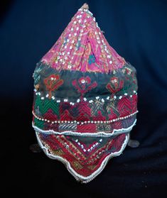 This is a cap from the Swat Valley in Pakistan. The Swat Valley is know for it's beautiful silk embroidered textiles. It is made of a cotton fabric embroidered in silk and decorated with glass and metallic beads. -Silk embroidery -Glass and metallic beads -Swat Valley Traditional Ceremonial Embroidered Fabric With Handwork, Ceremonial Embroidered Fabric With Handwork For Festivals, Handwork Embroidered Fabric For Ceremonial Festivals, Ceremonial Multicolor Embroidered Raw Silk Fabric, Ceremonial Multicolor Embroidered Fabric With Handwork, Traditional Embellished Embroidered Fabric For Ceremonies, Traditional Multicolor Embroidered Fabric For Ceremonial Use, Traditional Red Hat, Ceremonial Multicolor Embroidered Fabric