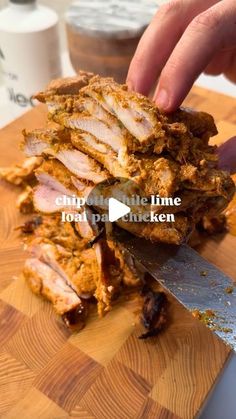 someone cutting up food on top of a wooden cutting board