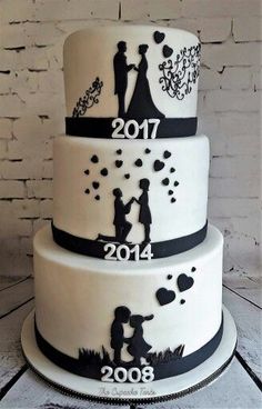 a wedding cake is decorated with black and white silhouettes