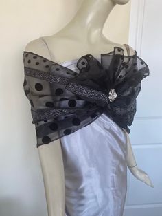 Elegant women's black organdy scarf with flocking. Silver accent. A sparkly accessory for special occasions. Drape on the neck as a traditional tie scarf or wrap around the shoulders as an elegant shawl. Semi sheer. Dry clean. ** Brooch not included. Black Wedding Shawl Scarf, Party Scarves In Organza, Elegant Black Scarves For Wedding, Elegant Organza Scarves For Party, Elegant Party Shawl Scarf, Printed Beach Dresses, Sparkly Accessories, Elegant Shawl, Formal Tops