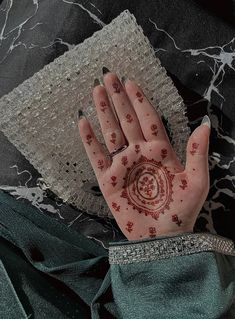 a person's hand with henna on it