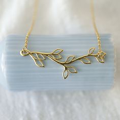 "Beautiful and lovely gold branch necklace made of gold plated branch with leaves pendent with skinny gold plated brass chain. Soft and natural. Great for everyday, special occasions or gift item. Your item will ship in a gift box. Please feel free to contact me if you have any questions. ♥ Chain length 14\" -20\" ♥ Branch 5/8\" x 2\" ♥ Gold plated over brass ♥ See more Rudiana Accessories Rudiana.etsy.com" Gold Nature-inspired Necklaces For Mother's Day, Gold Nature-inspired Necklace For Gift, Nature-inspired Gold Leaf Necklace, Pretzel Necklace, Branch With Leaves, Forest Necklace, Leaves Necklace, Gold Branches, Prom Necklaces