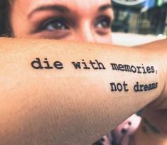 a woman with a tattoo on her arm that says, die with memories not dreams