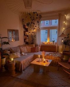 a living room filled with lots of furniture next to a large window covered in plants