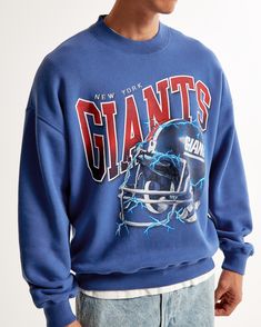 Show your team spirit in style with the Men's New York Giants Graphic Crew Sweatshirt from Abercrombie & Fitch. This piece combines comfort with fan pride, making it a must-have for any Giants supporter.

- Size: Small
- Color: Blue
- Material: SoftAF fleece fabric
- Gender: Male
- Age Group: Adult
- Features: Oversized-fit silhouette, New York Giants graphic on chest, crew neckline, banded hem and cuffs

Perfect for game day or casual wear, this sweatshirt ensures you stay cozy while cheering o Blue Sweats For Streetwear During Sports Season, Collegiate Crew Sweatshirt With Graphic Print, Throwback Logo Print Sweatshirt For Fall, Blue Sweats For Streetwear In Fall, Blue Sweats For Fall Streetwear, Fall Throwback Logo Print Sweatshirt, Collegiate Graphic Print Crew Neck Sweats, Blue Fleece Sweats With Letter Print, Graphic Print Sweats For Sports Season Streetwear