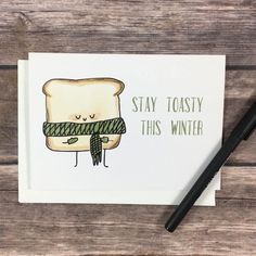 a piece of bread with a scarf on it and the words stay toasty this winter